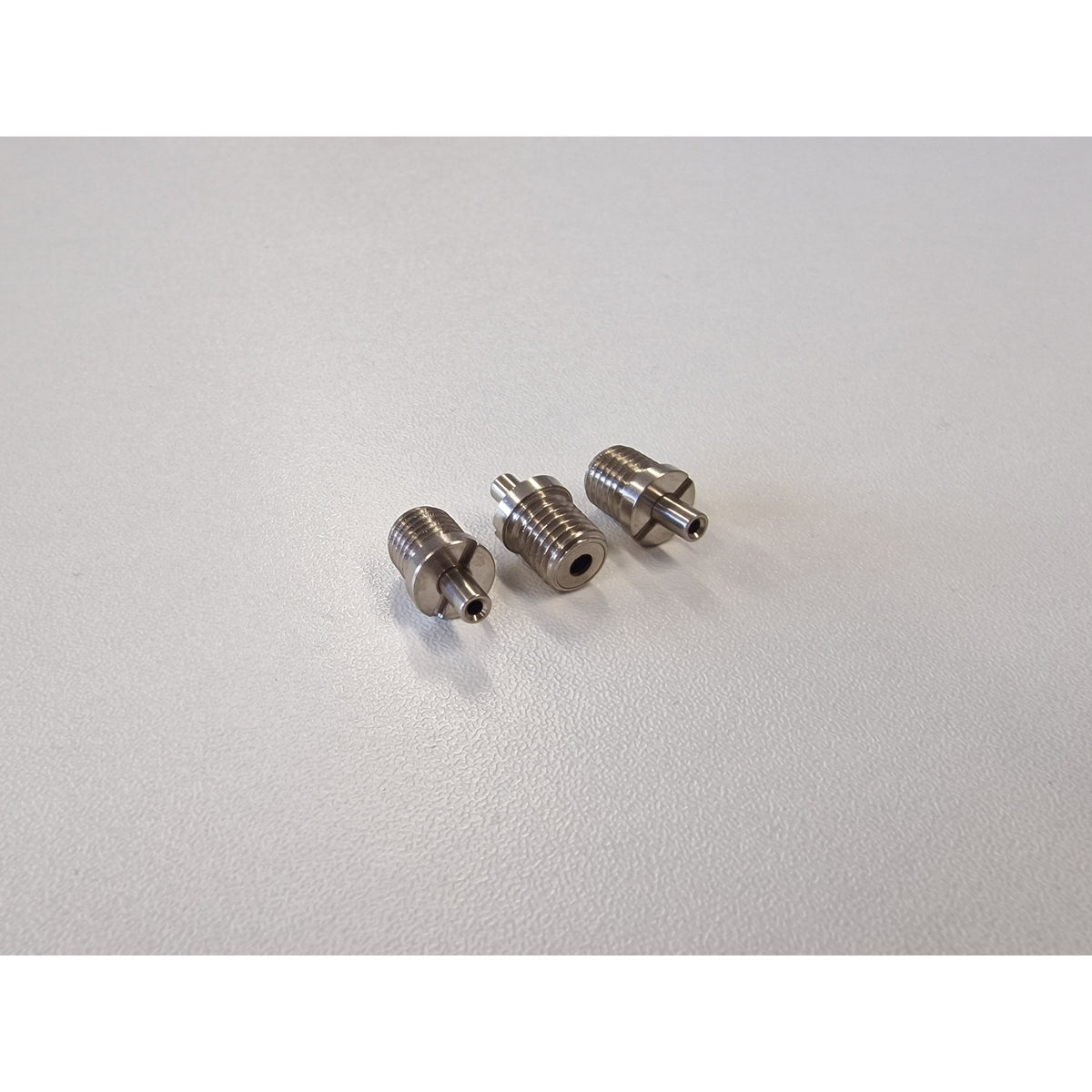 Three Metallic TECNI cable Grippers on a white table 170.012.002