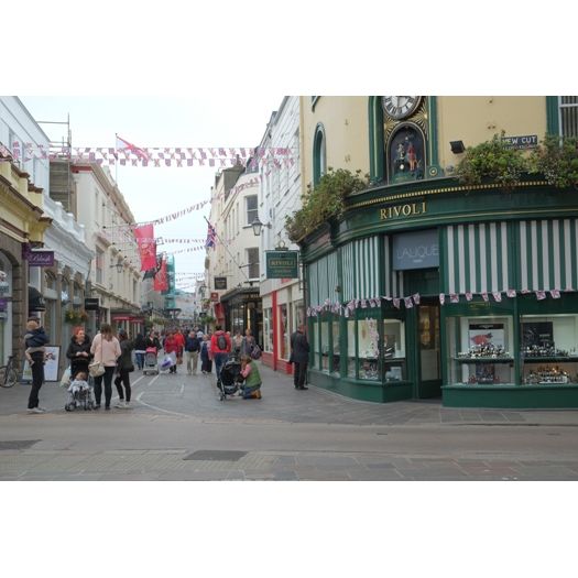 Stainless Steel & Galvanised Catenary Systems in an exterior Street scene with pedestrians and shops in a town center