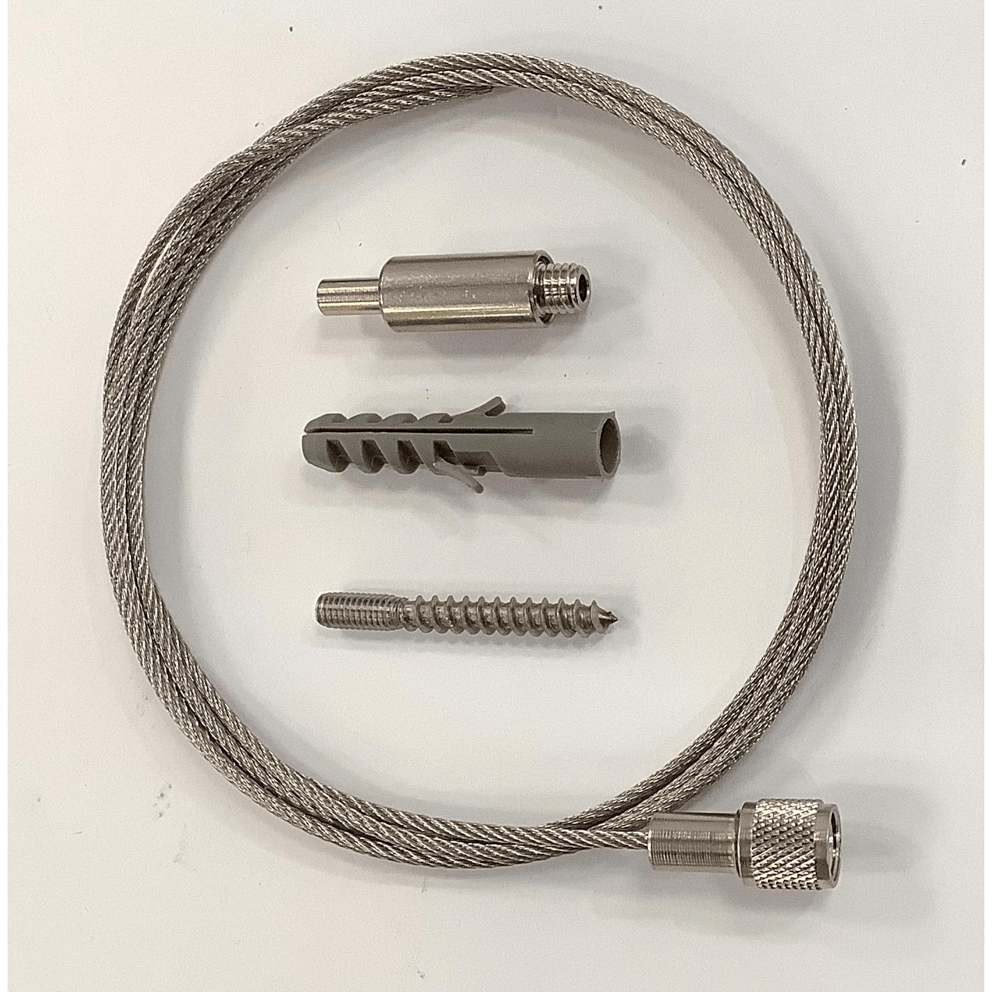 A threaded cable suspension kit laid out on a white surface, including a steel cable, ceiling attachment,and mounting hardware.