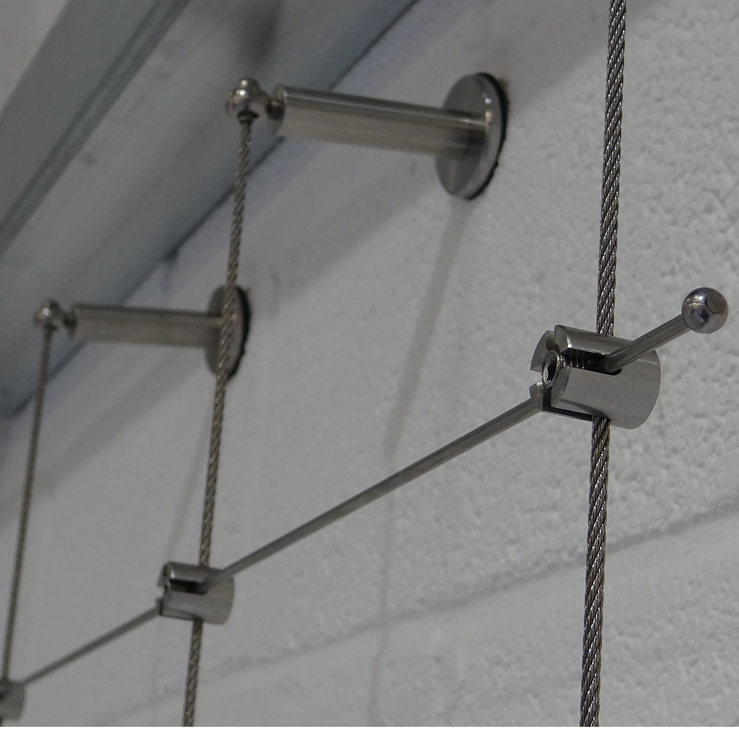 Close up photo of the components of trellis fitted onto a white wall