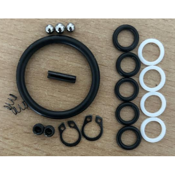 Set of black and white rubber rings and metal components on a wooden surface
