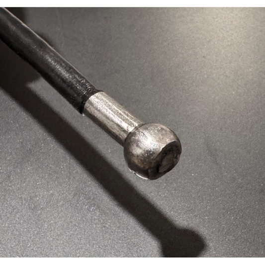 Black Nylon coated wire rope with ball shank one end on a black background