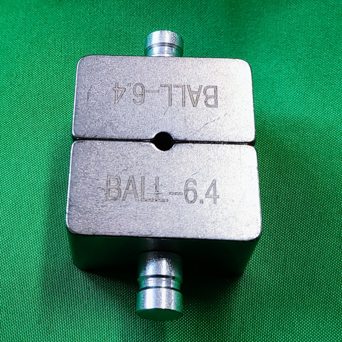 Close up photo of a TECNI YCP-240C die set on green background showing top and bottom die put together. 