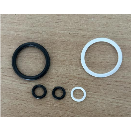 Set of black and white gaskets on a wooden surface